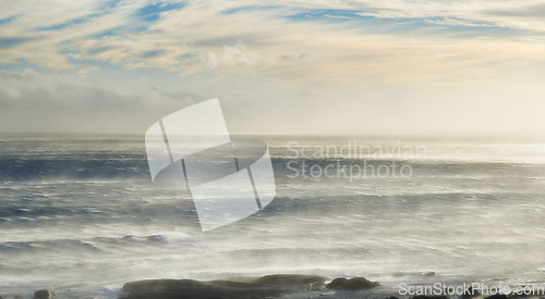 Image of Water, sky and sunrise with waves or clouds in nature or outdoor for vacation, relax and travel. Horizon, sea and wind or wave and ocean landscape for a holiday or calm in the environment with light.