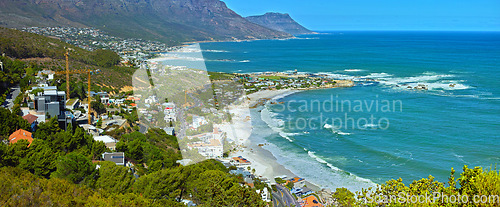 Image of Mountain, nature and city by beach in South Africa for tourism, traveling and global destination. Landscape, background and scenic view of ocean by urban town for adventure, vacation and holiday