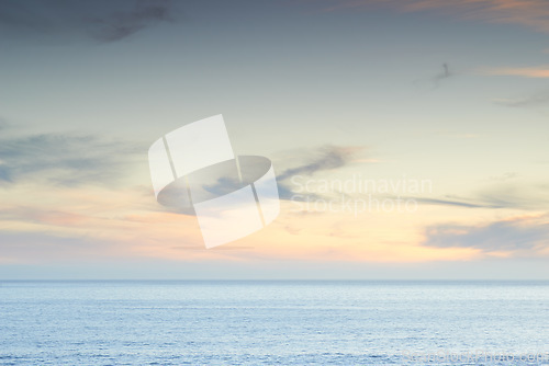 Image of Beach, sunset and sky by the ocean for travel with a seascape or tropical vacation in Australia. Nature, island and sea water waves in the evening for an outdoor paradise holiday or weekend trip.