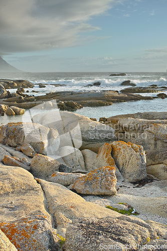 Image of Ocean, rocks and landscape with beach and travel, waves and summer vacation outdoor. Environment, sea view and seaside location with tropical destination and journey on island, nature and adventure