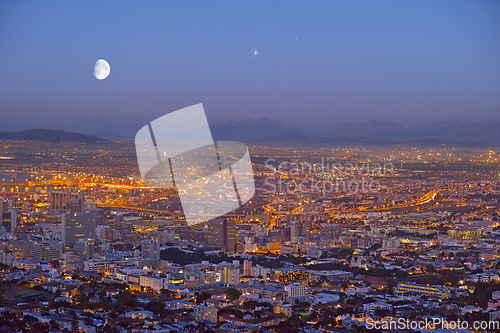 Image of City, Cape Town and night view of building lights and architecture in the industrial urban town of South Africa. Late evening of outdoor scenery of moon or sky over buildings or cityscape structures