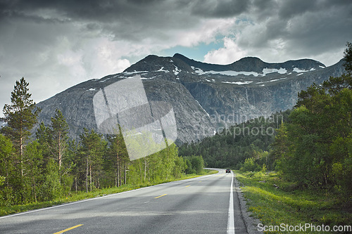 Image of Road, mountain and travel landscape, trees and nature with direction and destination with asphalt and highway. Environment, street and location with journey and traveling view outdoor with horizon