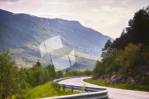 Image of Road, mountain and travel with nature landscape, direction and destination with asphalt in Norway. Environment, street and location, journey and traveling view outdoor with horizon and countryside