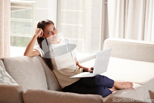 Image of Laptop, home and portrait of a woman on a sofa with internet connection for streaming online. Happy female person relax on couch with technology for communication, social media and reading email
