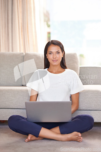 Image of Laptop, home and portrait of a woman on lounge floor with internet connection for streaming online. Female person or student relax in a house for remote work, studying and research or email for blog