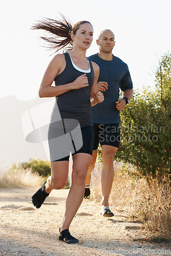 Image of Mountain, fitness and people trail running as workout or morning exercise for health and wellness together. Sport, man and woman runner run with athlete as training in nature for sports or energy