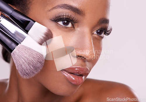 Image of Beauty product, makeup and black woman with brush on face in studio with cosmetic application tool. Skincare, blush and cosmetics, facial skin care model with luxury contour powder on pink background