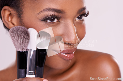 Image of Cosmetic brushes, makeup and black woman with smile on face in studio and beauty application tool. Skincare, blush and cosmetics, facial skin model with luxury contour product on white background