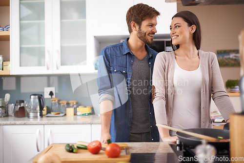Image of Love, food and happy couple in kitchen cooking, smile and preparing lunch in their home together. Dinner, date and man with woman for natural nutrition and vegan meal prep in their apartment