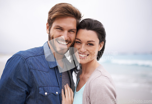 Image of Portrait, hug and couple at a beach with love for travel, romance and freedom together outdoors. Face, smile and happy woman embracing man on trip, vacation or holiday, bond and having fun in Cancun