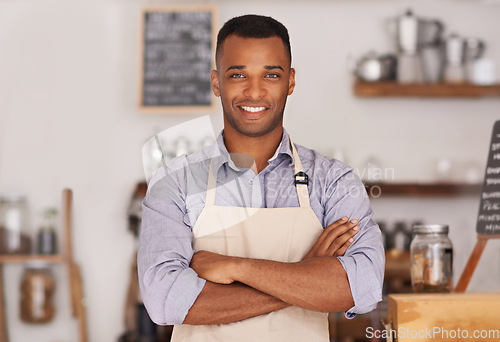 Image of Black man, portrait smile and barista with arms crossed in cafe with pride for career or job. Waiter, happy and confidence of African person from Nigeria in restaurant, small business and coffee shop