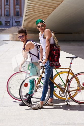 Image of Bicycle, portrait and friends or men in city streetwear for college, university or outdoor travel in summer. Cool youth or people with gen z fashion, sunglasses and bike for urban transport at campus