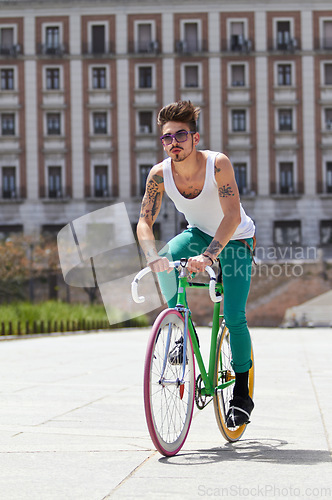 Image of Bicycle, fitness and young man in city for travel and carbon footprint, gen z streetwear and casual fashion. Cool person or student in sunglasses and bike transport for exercise at campus building