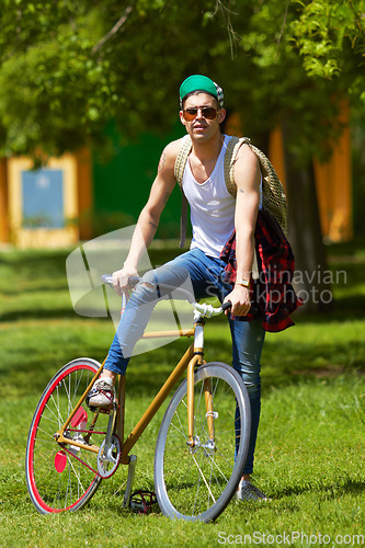 Image of Bicycle, park and portrait of young man for travel, journey and carbon footprint, streetwear and cool fashion at university. Person or college student in sunglasses, bike transport and outdoor campus