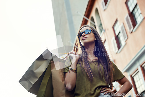 Image of Shopping bag, fashion confidence and woman with clothes purchase, retail product or luxury boutique discount. Urban city, sales spree and chic female customer with glasses, design brand or mall gift