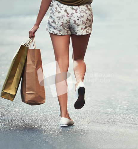 Image of Shopping bag, street or legs of woman, walking and travel on urban city road after Black Friday discount. Retail, boutique fashion gift or back of customer with mall store purchase on concrete ground
