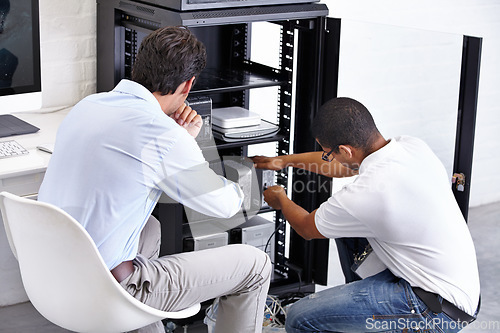 Image of Server room, man and technician working with electronics for hardware maintenance of glitch in office. IT support, worker and electrical engineer fixing internet connection for information technology