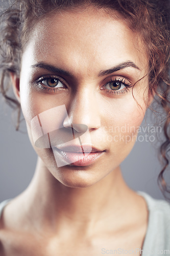 Image of Beauty, face and portrait of woman in studio confident, beautiful and gorgeous on gray background. Salon, attractive and closeup of female person with natural makeup, cosmetics and curly hairstyle