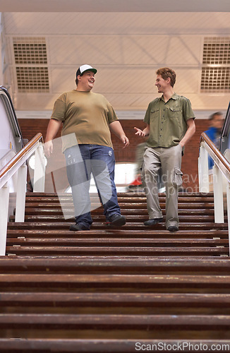 Image of Student, teenager friends and campus boys walking down university and school steps with a smile. Conversation, talking and discussion of guy group feeling happy on education building stairs with talk