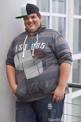 Image of Plus size, young man and portrait outdoor with hipster and urban style with a smile. Happy, gen z fashion and cool clothing of a heavy male person with youth and confidence with hands in pockets