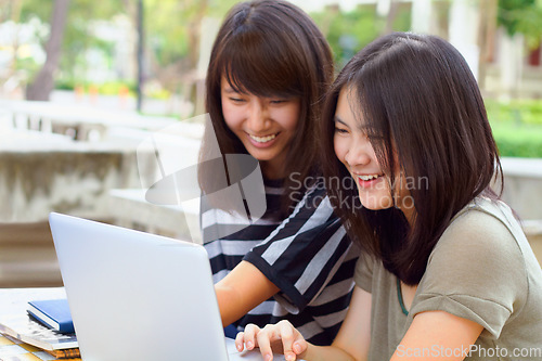 Image of Laptop, university and female students studying outdoor on campus for a test, exam or assignment. Happy, smile and women doing research or browsing for education information on a computer at college.