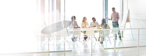 Image of Data review, colleagues and chart in a business meeting of their modern workstation with a lens flare. Teamwork or collaboration, planning or brainstorming and people working together in a boardroom