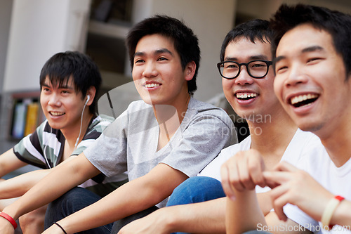 Image of Happy, relax and men together on the weekend for happiness, friendship and bonding. Smile, teenager and Asian friends laughing, talking and having fun while watching a soccer game or competition