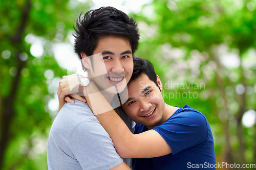 Image of Asian men, gay couple and hug by trees, portrait and woods with love, care and bonding in summer sunshine. Happy Japanese man, romance and relax together in forrest with lgbtq, nature and holiday