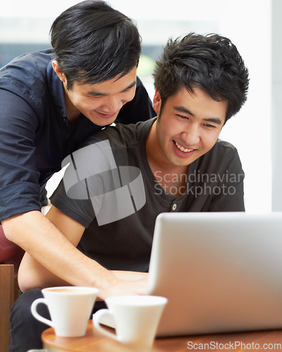 Image of Happy, streaming and a gay couple with a laptop for a movie, internet search or reading email. Smile, love and Asian men with a computer for online information, movie choice or show together