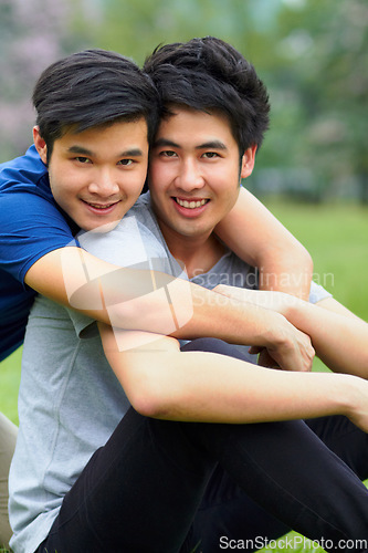 Image of Asian men, gay couple and hug in park portrait, grass or garden with love, care and bonding in summer sunshine. Happy Japanese guy, romance or relax together on lawn with lgbtq, nature and holiday