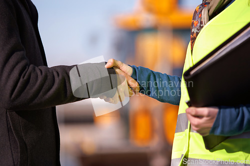 Image of Construction site, handshake and people in industry partnership, thank you and success or engineering deal. B2b, building contractor and architecture meeting of business person shaking hands closeup