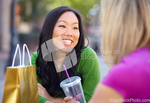 Image of Shopping, coffee shop and friends in the city for lunch together while bonding over a retail sale. Cafe, smile or happy with an asian woman customer and friends talking outdoor in an urban town