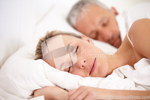 Image of Relax, bed and a mature couple sleeping for fatigue, rest and dreaming together. Peace, house and a tired man and woman enjoying a nap, bedroom sleep or resting at night during retirement relaxation