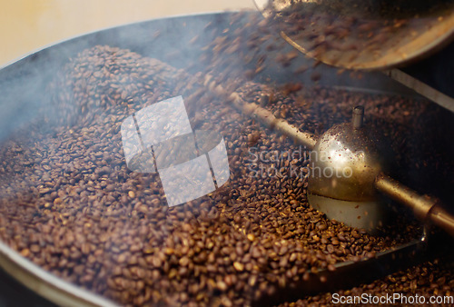 Image of Cafe, mix and coffee beans in a machine for a raw blend, textures and steam in a pot. Food, industry and espresso and caffeine product premium grain as an export or import for trade and drink