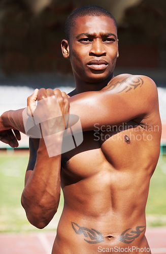 Image of Body, stretching and man runner at a stadium for fitness, training and workout, warm up and focus. Start, stretch and African male athlete at a race track for cardio, exercise and sports performance