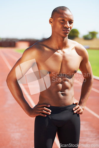 Image of Body, mindset and topless man at a race track for training, fitness and sport, cardio and speed running practice. Stadium, start and African male runner serious, focus and ready for performance run