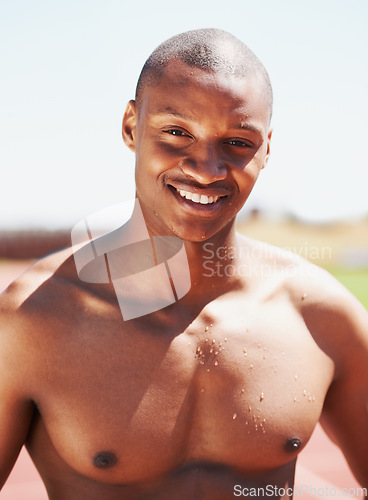 Image of Fitness, portrait and happy man runner at a race track for health, exercise and cardio routine. Smile, face and topless African male athlete at a stadium for performance, challenge and training run