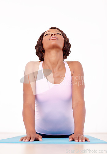 Image of Woman, yoga and stretching in fitness for zen, spiritual wellness or pilates workout on the mat. African female yogi in svanasana pose for healthy body, relax or warm up stretch in training exercise