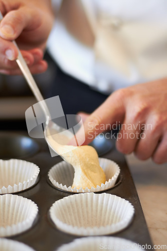 Image of Closeup, hands and muffin dough in tray with baker, small business owner and professional chef. Cooking, bakery and cake in baking pan for food, job or start process for cupcake in restaurant kitchen