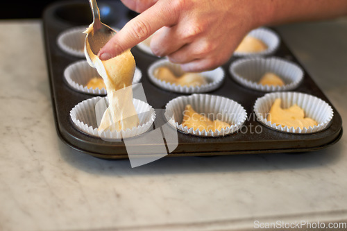 Image of Closeup, tray and hand for cupcake dough with baker, small business owner and professional chef. Cooking, bakery and cake in baking pan for food, job or start process for muffin in restaurant kitchen