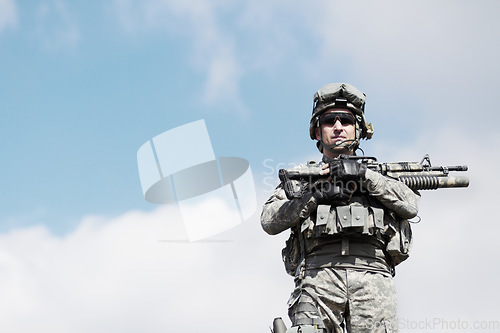 Image of Soldier man, machine gun and outdoor portrait by sky background for mockup space in war, fight or army. Military service, battlefield and agent with weapon, gear or sunglasses for conflict in Ukraine