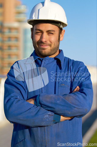 Image of Man, architect and portrait smile in construction with arms crossed and hard hat in the city. Male person, engineer or contractor smiling in confidence for industrial architecture or building in town