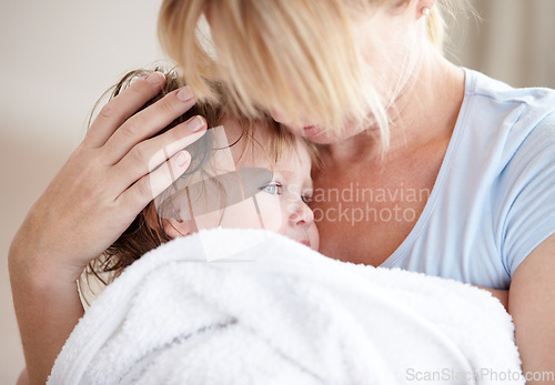 Image of Hug, love and a mother with a child after a bath for heat, care and cuddling. Family, comfort and a mom holding a baby after a wash, hugging and embracing for closeness, bonding and affection