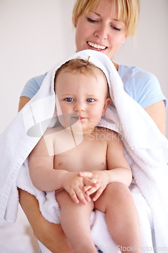 Image of Baby, mom and hug for bath with care in a closeup for clean kid at home with love and caring. Towel, mother and infant with portrait to hold or hugs for care and love with kid in family home.