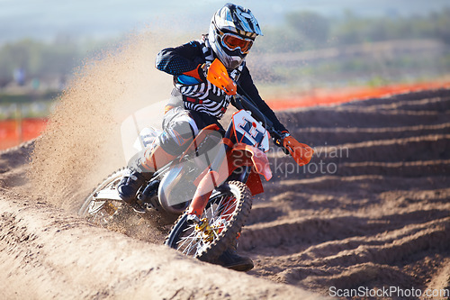 Image of Motorbike, sport and action with dirt for competition with power or speed on course for transportation. Race, bike and professional driver in desert for adventure or sports at a rally with energy.