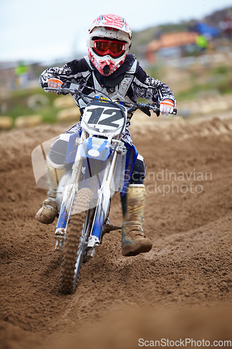 Image of Motorcross, dirt road and athlete riding bike with speed for a race or sports competition. Challenge, fitness and man biker on motorcycle for adrenaline, training or practicing on outdoor mud trail.