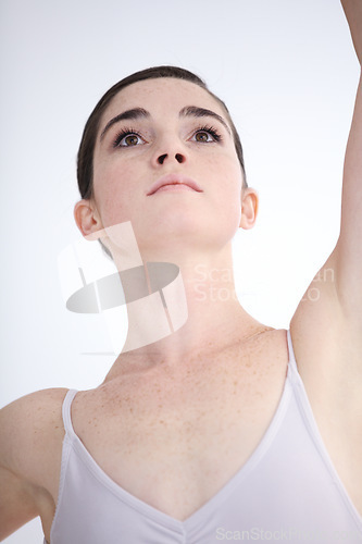 Image of Dance, closeup of ballerina woman and in a white background isolated. Ballet or dancer, balance fitness and female person dancing alone in a studio backdrop for health wellness or creative art