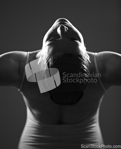 Image of Dance, ballet and monochrome with a woman in studio on a dark background for creative, art or expression. Theatre, broadway or performance with a young female ballerina or dancer in black and white