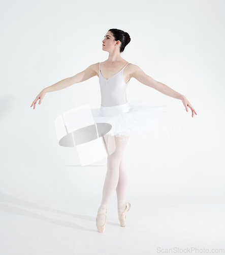 Image of Dance, ballet and performance with woman in studio for balance, elegant and creative. Artist, theatre and training with ballerina dancing ion white background for competition, freedom and commitment