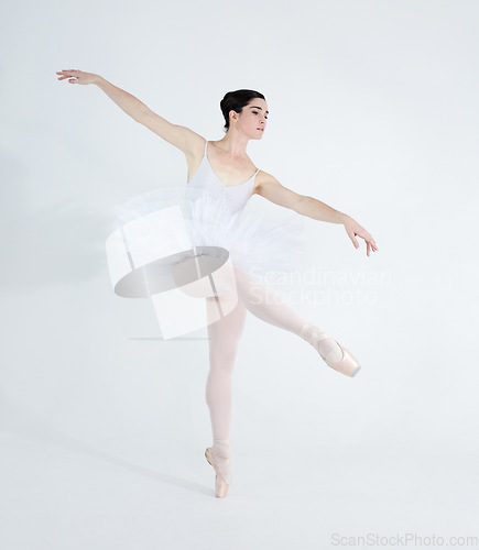 Image of Dance, ballet and elegant with woman in studio for balance, creative and performance. Artist, theatre and training with ballerina dancing ion white background for competition, freedom and commitment